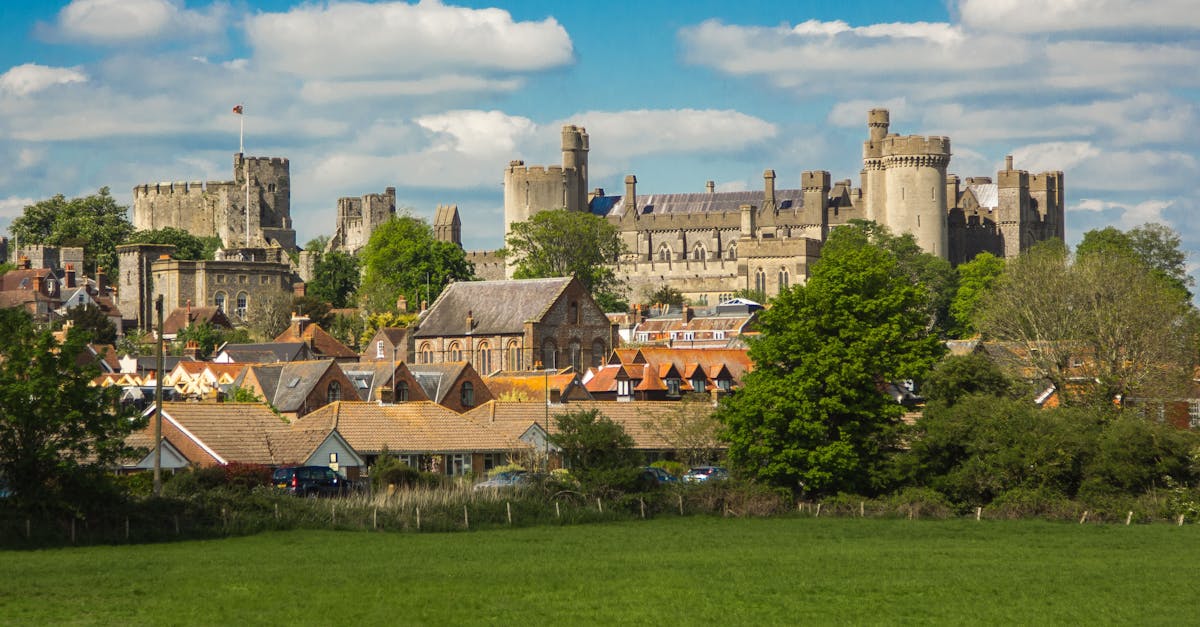 Beautiful landscape view of Arundel Castle with the town below, under a clear blue sky.