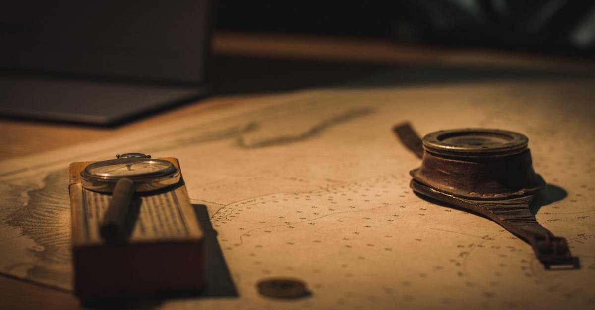 A vintage compass and magnifying glass on an old nautical map evoke a sense of adventure and discovery.