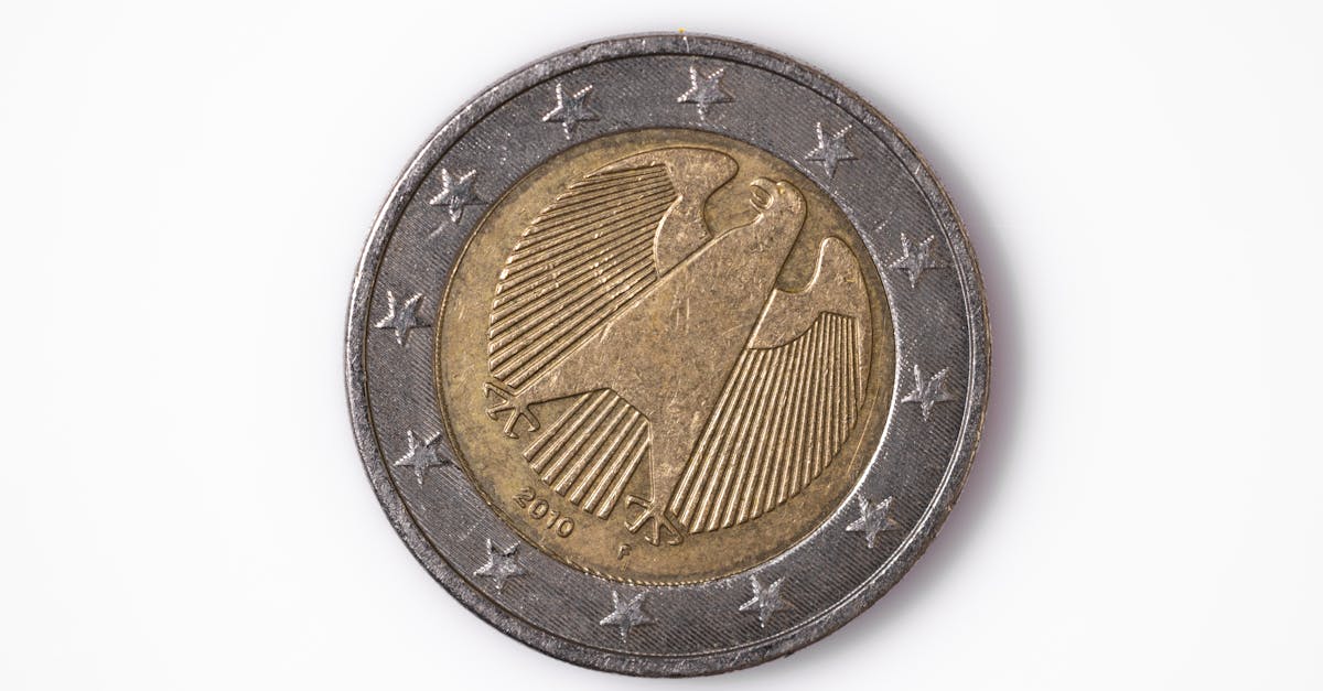 Macro photo of a 2 euro coin featuring a detailed design with stars on a white background.