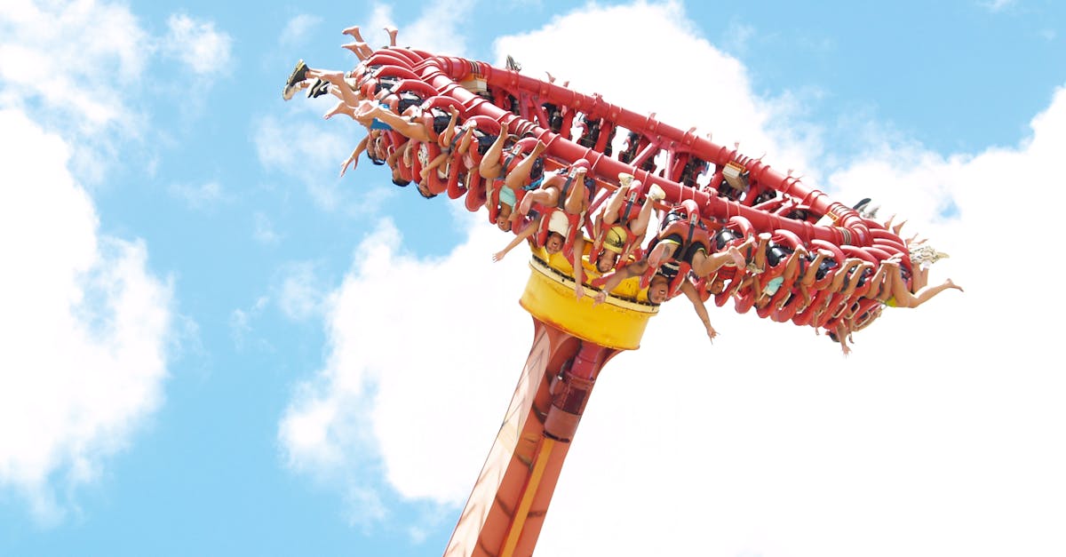 Experience the thrill of an extreme amusement park ride against a clear blue sky