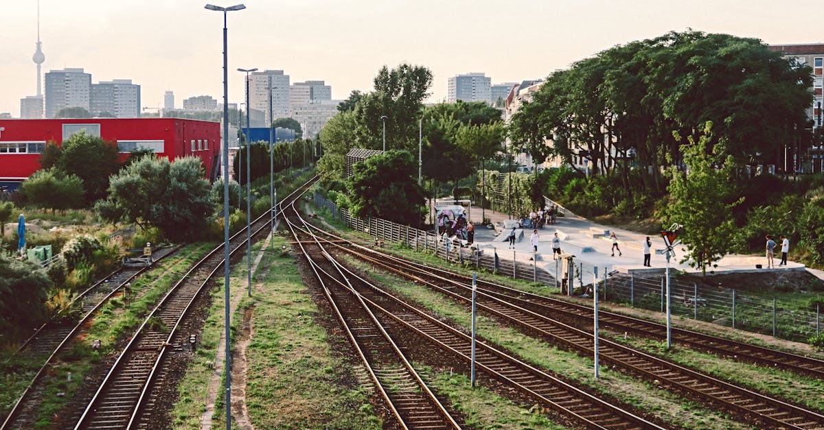 Railway tracks in Berlin with a view of the TV Tower and a nearby skatepark.