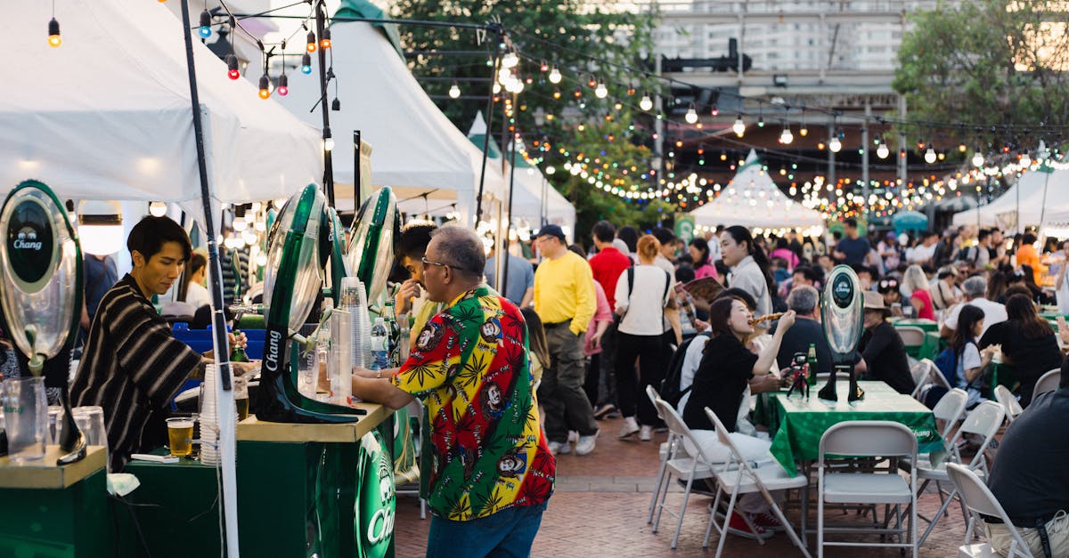Lively outdoor food festival in Bangkok with bustling crowd and colorful lights.