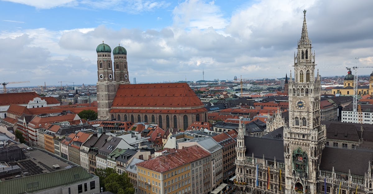 Stunning aerial view of Munich's Marienplatz with the New Town Hall and Frauenkirche under a vibrant sky.