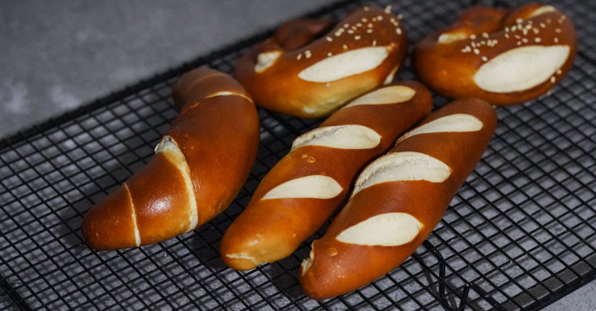 Close-up of freshly baked Bavarian pretzels cooling on a rack, showcasing their golden-brown texture.