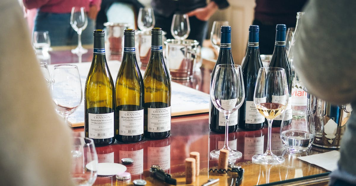 A vibrant wine tasting event showcasing bottles and glasses on a table in Beaune, France.