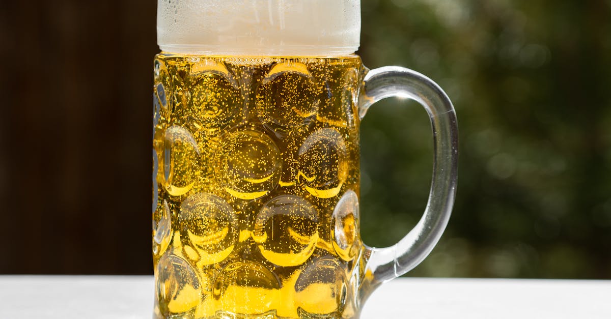 A refreshing glass of golden lager beer with frothy head, served outdoors in Munich, Germany.