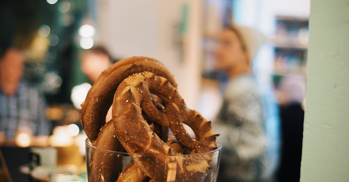 Appetizing pretzels in a glass jar, captured in a cozy café atmosphere.