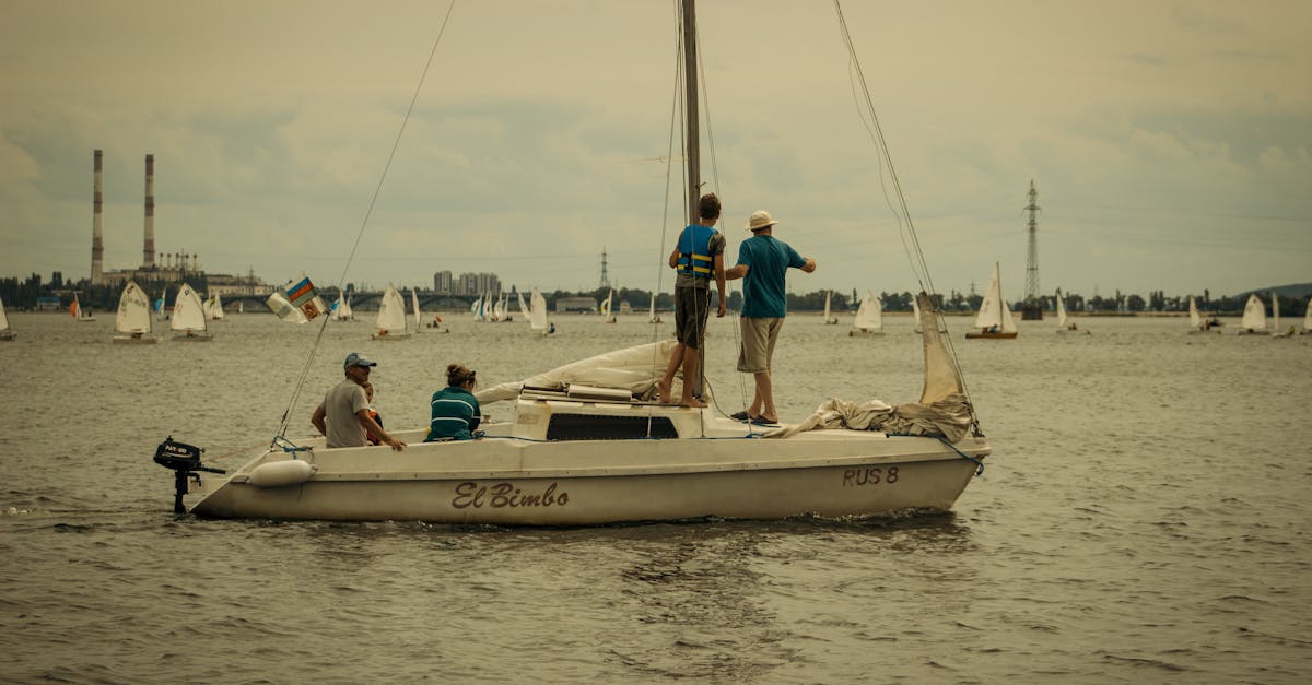 Adults enjoying a sailing adventure on a yacht with city skyline in the background.