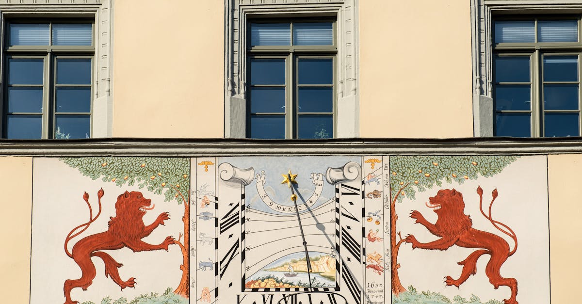 Detailed sundial with lion motifs on Dresden's architectural facade.