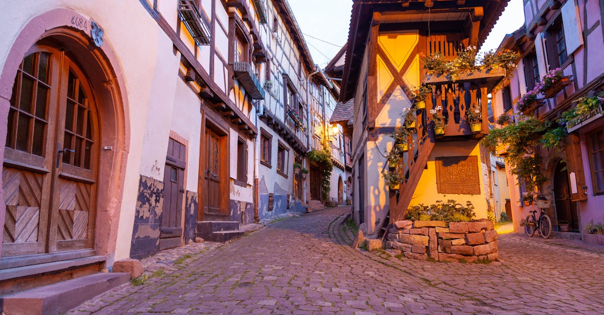 Picturesque cobblestone street in Eguisheim, showcasing traditional Alsatian architecture.