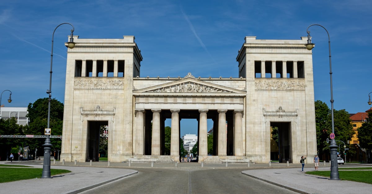 Historic Propylaea Gate in Munich's Königsplatz under a clear sky.