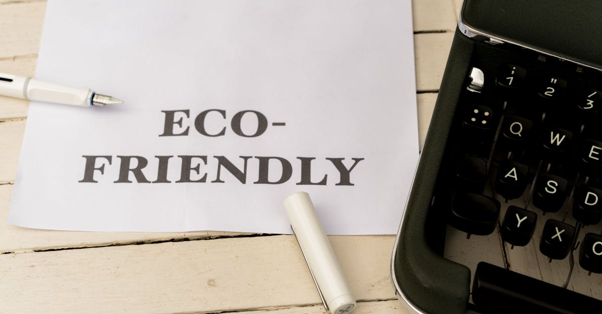 Image of eco-friendly text on paper with a vintage typewriter and pen on a wooden desk.