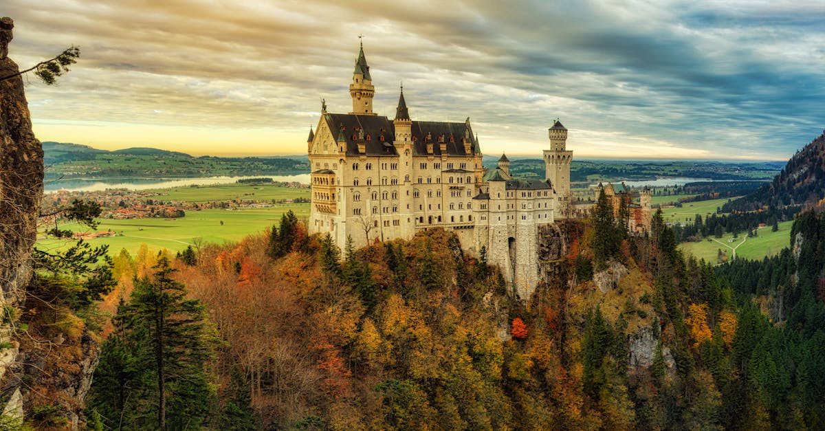 Stunning view of Neuschwanstein Castle surrounded by autumn foliage in Schwangau, Bavaria.