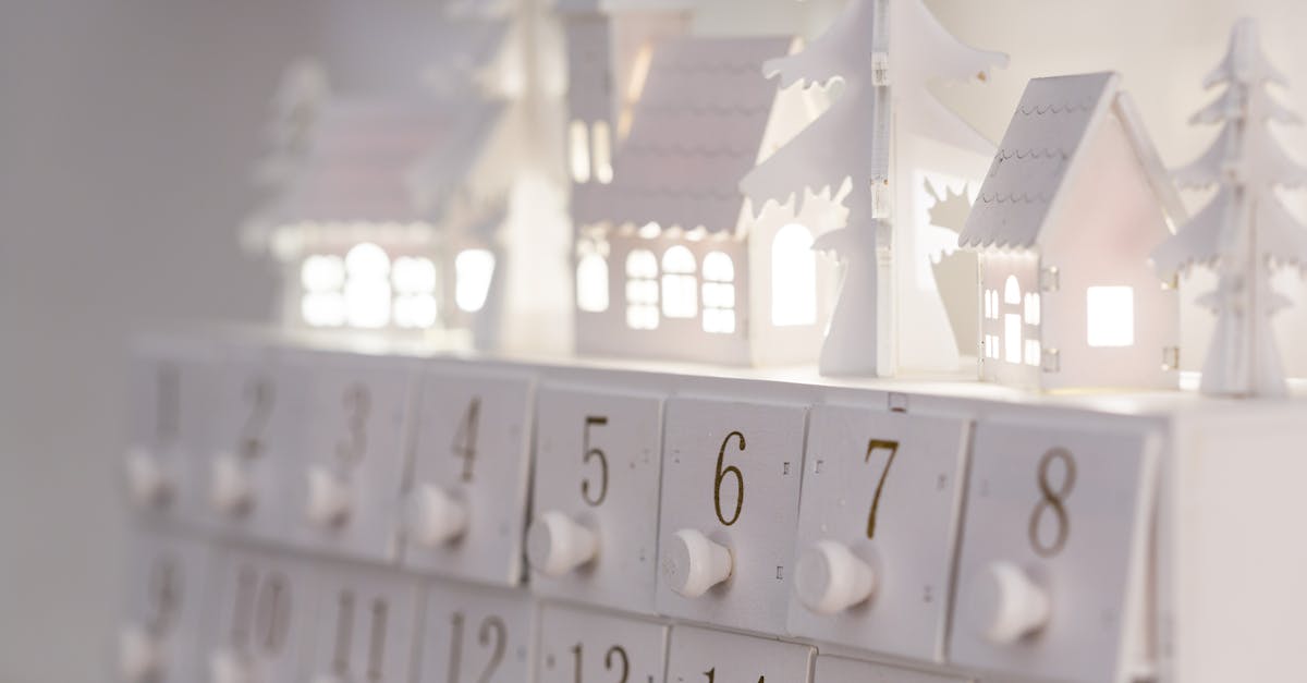 Beautiful minimalist advent calendar with illuminated houses and numbers for winter decor and festive ambiance.