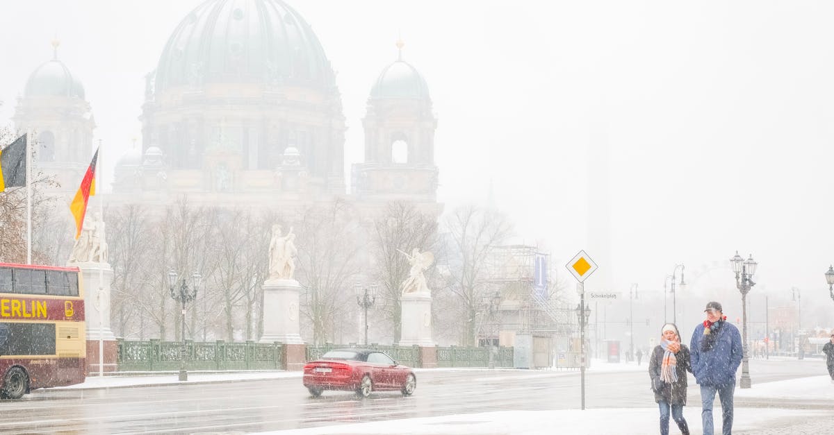 Winter scene in Berlin with snowy streets and pedestrians by Berlin Cathedral.