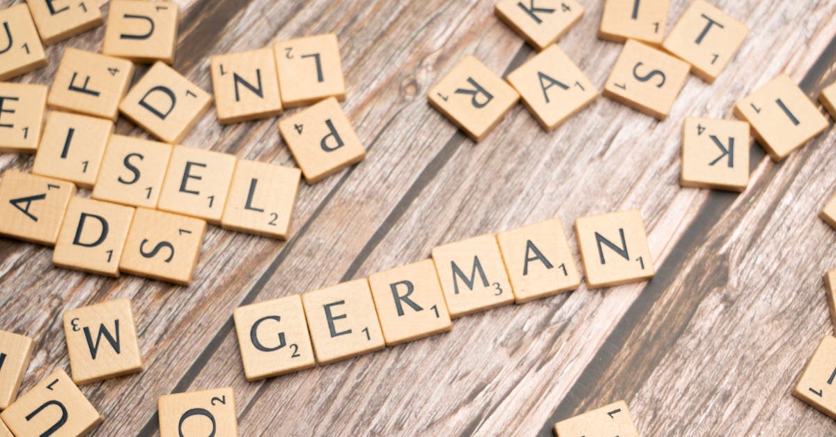 Wooden letter tiles on a table spelling out 'German'. Perfect for language, culture, or typography themes.