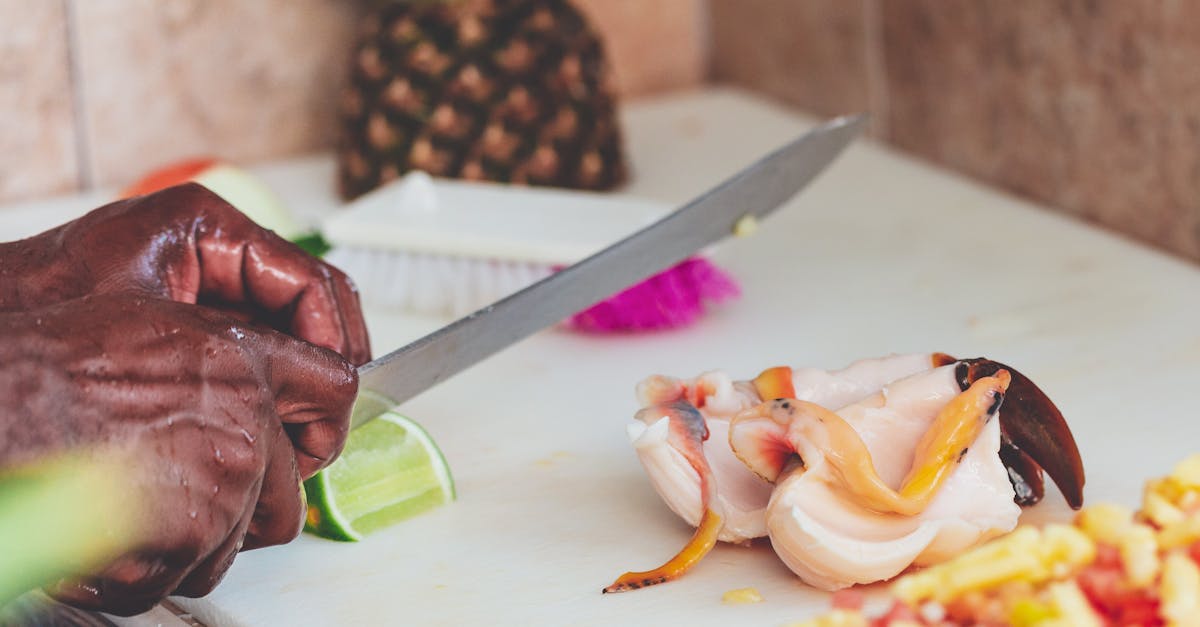 Close-up of preparing fresh conch salad with lime and pineapple in a Bahamian kitchen.