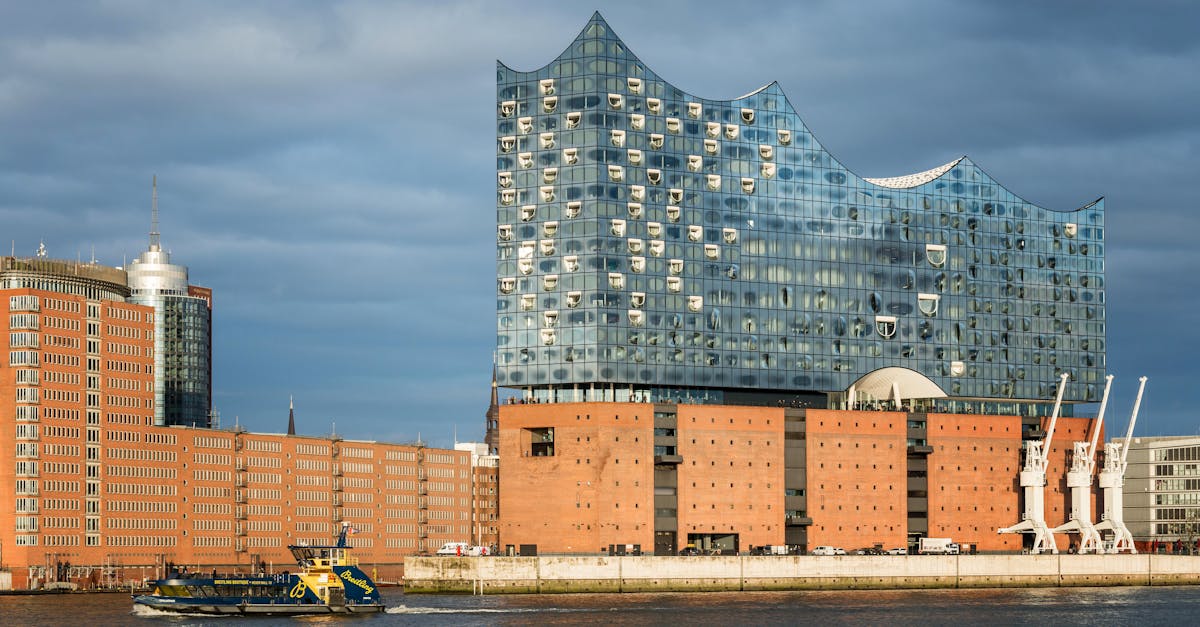 Stunning view of Elbphilharmonie in Hamburg, showcasing modern architecture with a ferry on the river.