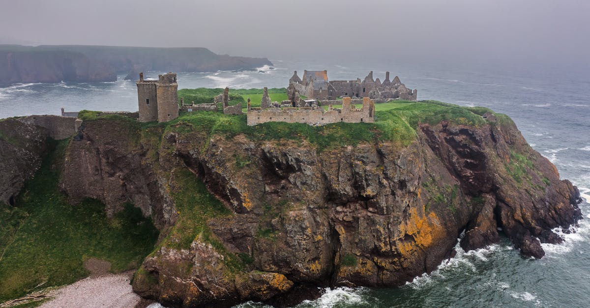 Drone capture of Dunnottar Castle perched on cliffs by the sea in Scotland.