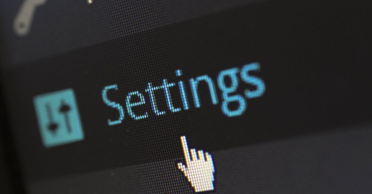 A close-up photo of a computer screen showing the settings button with a cursor hovering over it.