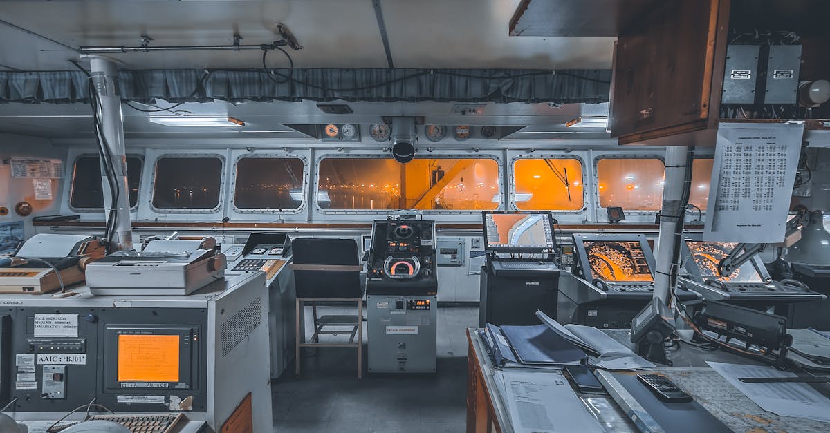 Interior view of a ship's control bridge with navigation technology and machinery.