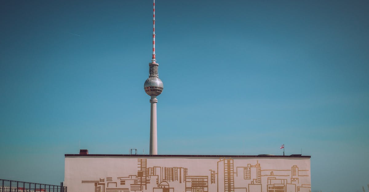 Captivating view of Berlin's Fernsehturm with a clear blue sky, showcasing modern architecture.