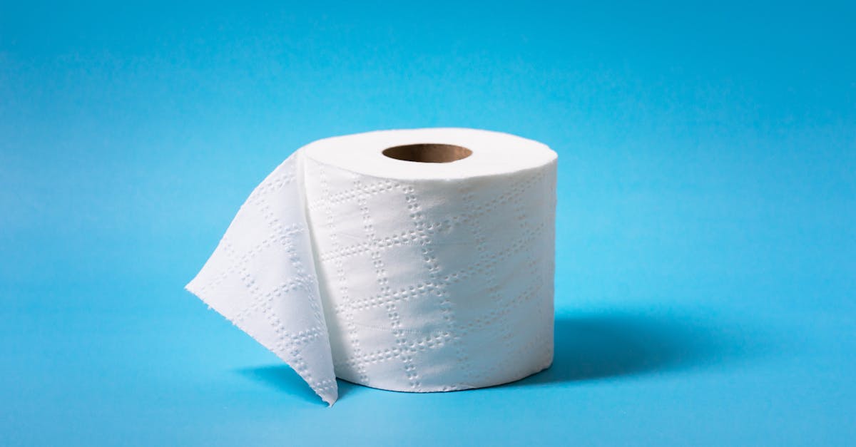 A single roll of toilet paper is isolated against a vibrant blue background, offering ample copy space.