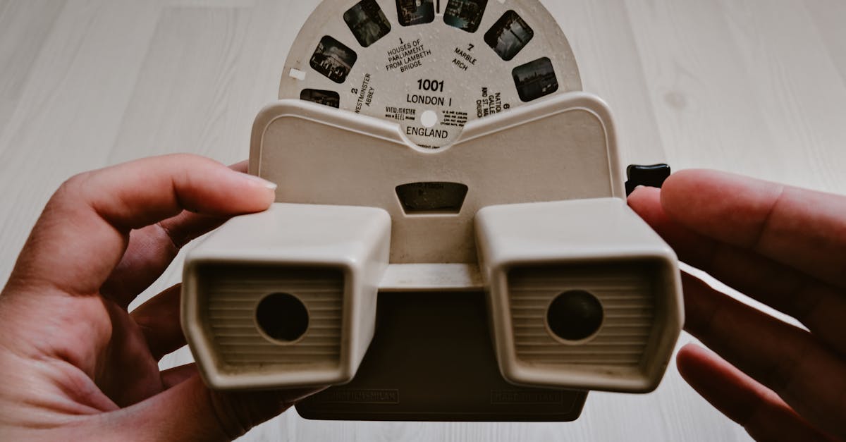 Close-up of a retro View-Master held by hands, displaying slide reels.