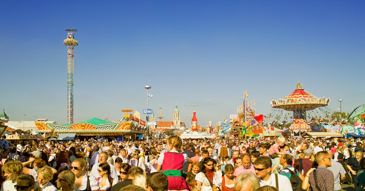 A lively scene at a crowded amusement park during the day.