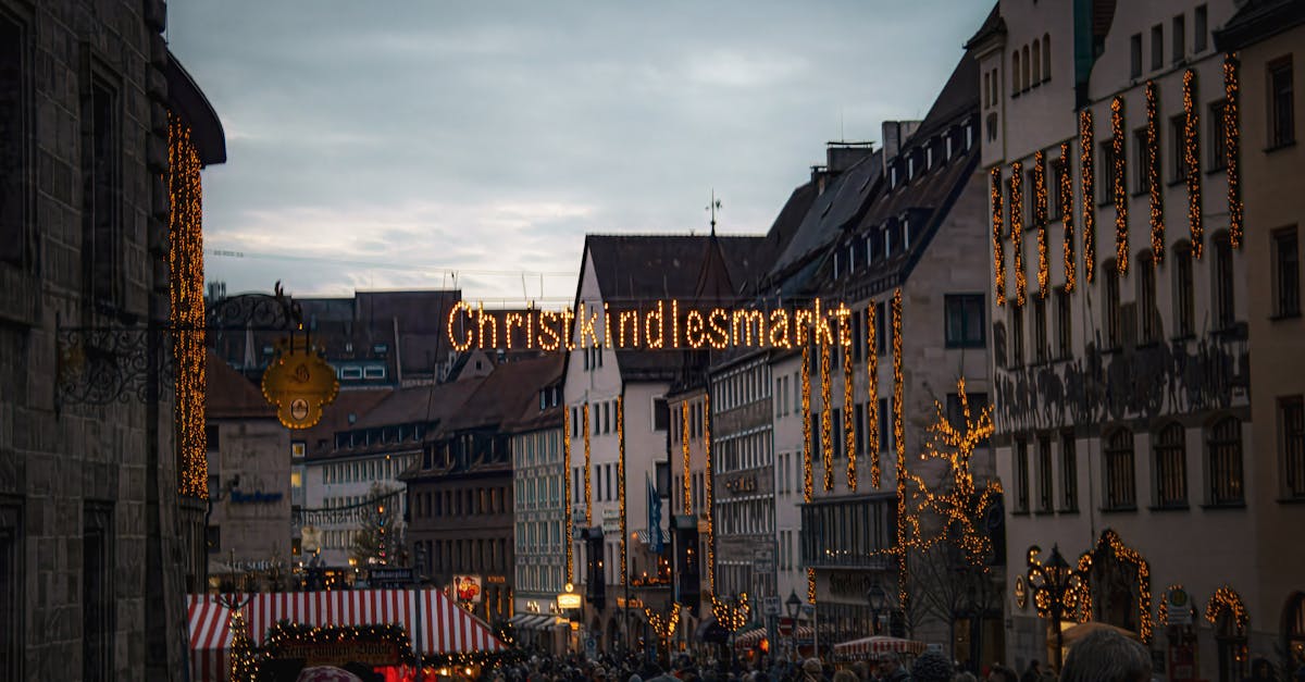 Evening view of the bustling Christkindlesmarkt in Germany, glowing with festive lights and winter charm.
