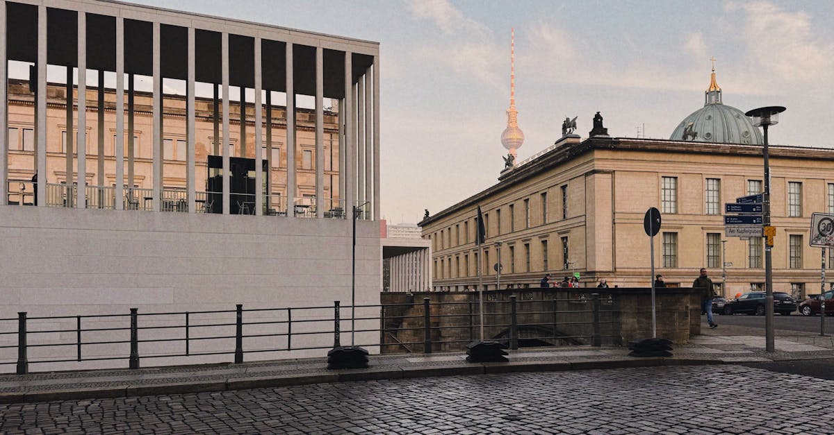 Modern and classic Berlin architecture featuring the iconic Fernsehturm under a clear sky.
