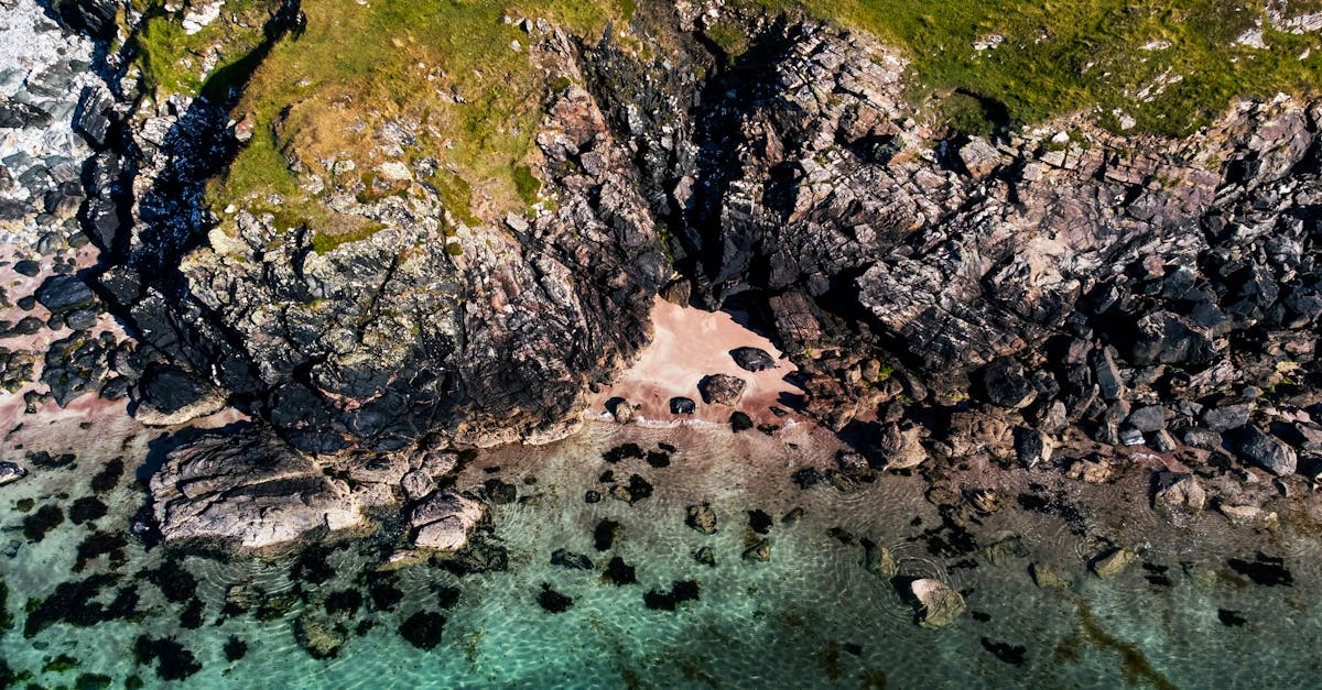 Explore the tranquil beauty of Scotland's rugged coastline with this aerial seaside view.
