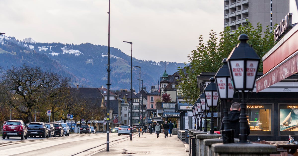 Charming street scene in Interlaken with snow-capped mountains in the background.