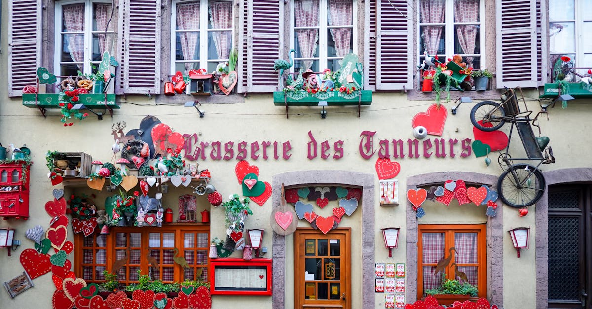 Colorful storefront with heart decorations on a French building showcasing unique style.