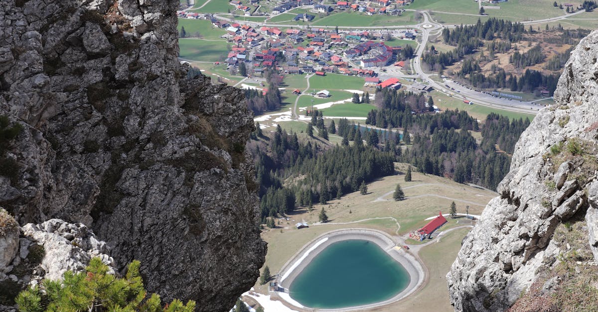 Breathtaking aerial shot of Salzburg's alpine village with lush greenery and rocky cliffs.