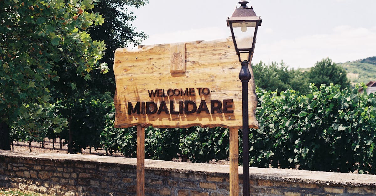 Welcome sign at Midalidare Vineyard with lush greenery background.