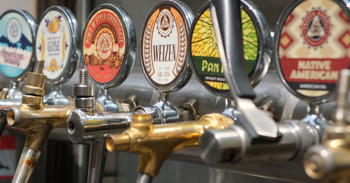 Close-up of craft beer taps with diverse labels in a bar setting. Ideal for beverages and brewery themes.