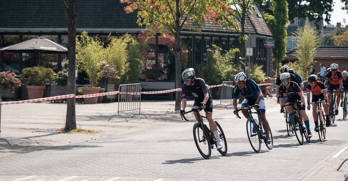 Exciting urban cycling race with athletes in competitive gear speeding through a city street.