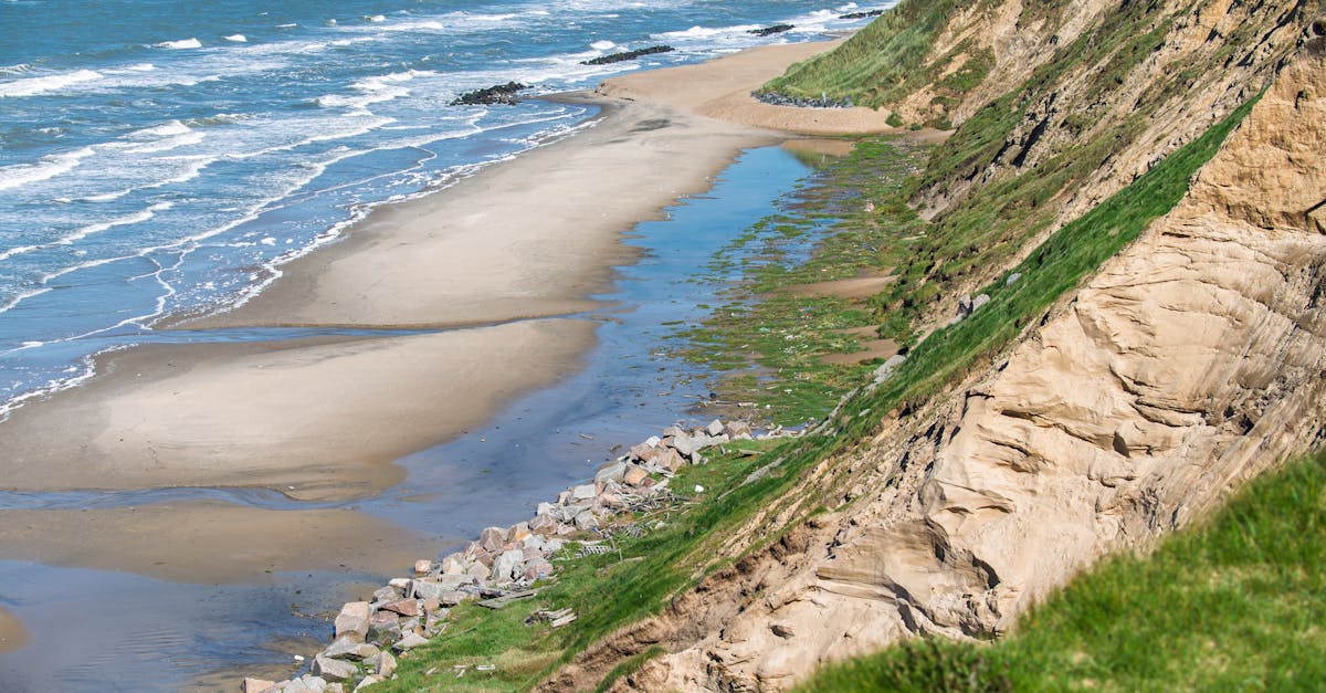Breathtaking view of coastal cliffs and sandy beach by the North Sea, showcasing nature's beauty.
