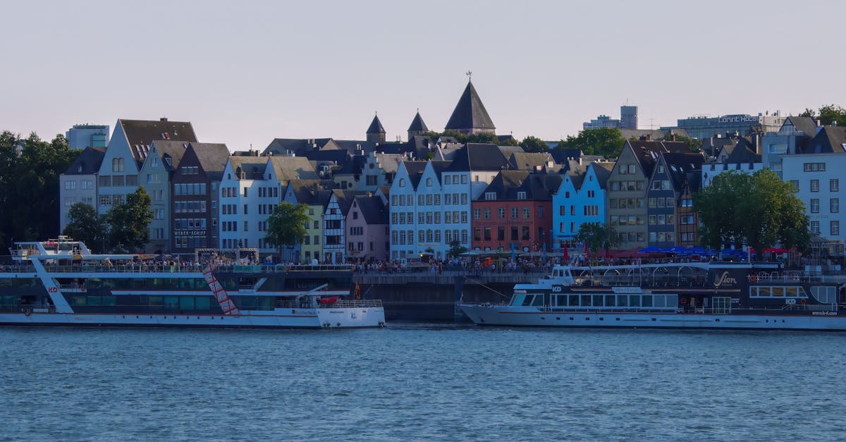 Charming waterfront view with colorful buildings and boats on the Rhine River.