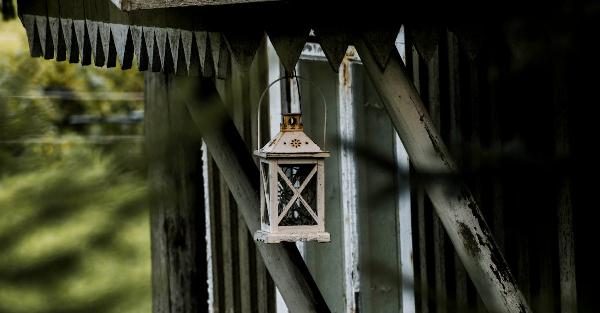 A vintage-style lantern hangs from a weathered wooden structure, evoking a rustic, peaceful mood.