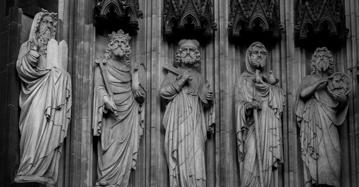 Intricate black and white statues adorn the Cologne Cathedral's gothic facade.