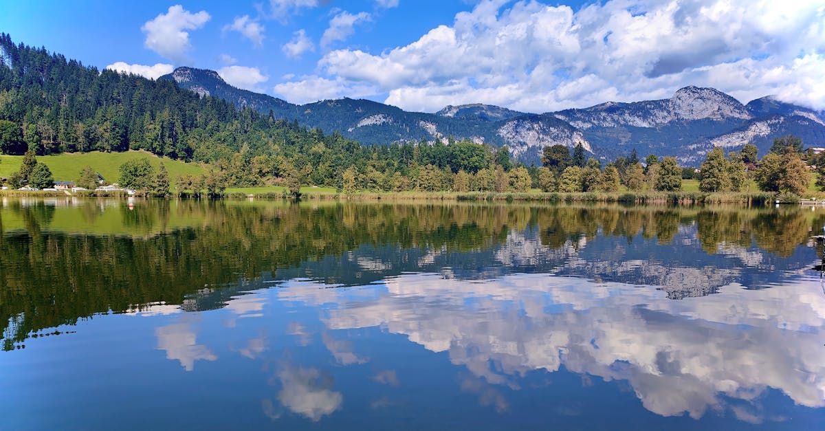 Stunning view of an alpine lake reflecting mountains and sky in Styria, Austria.