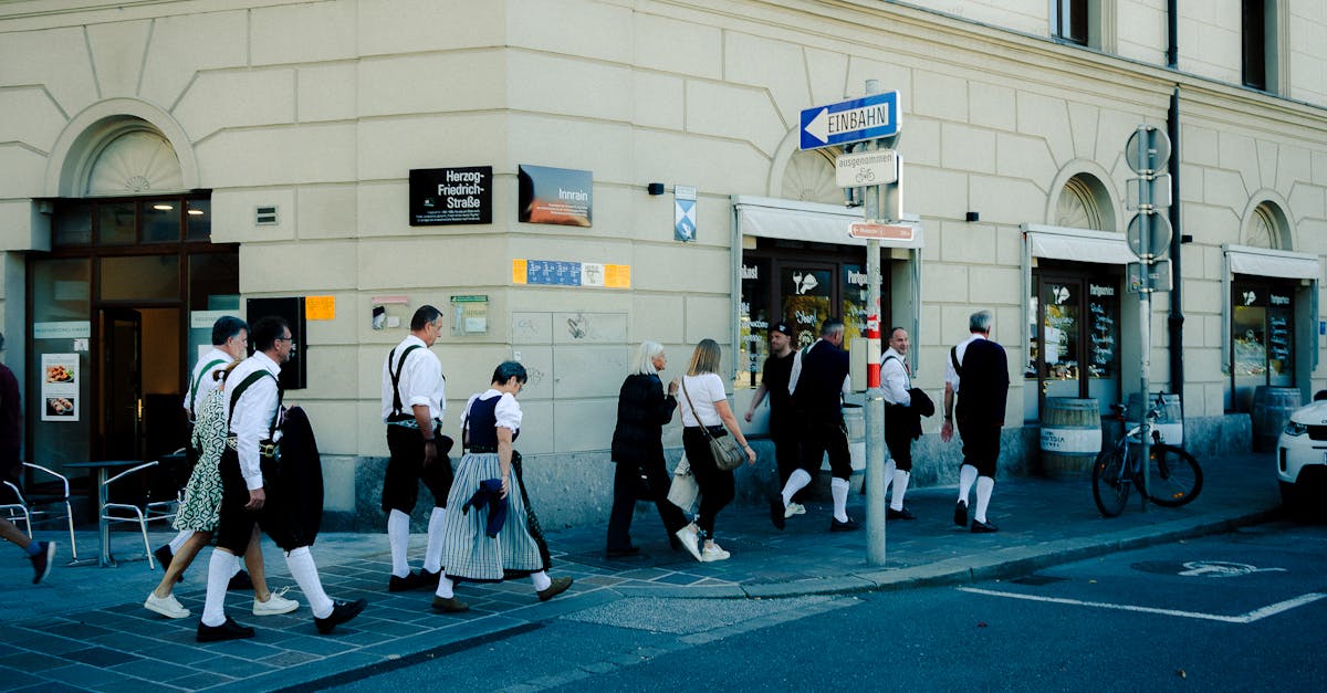 People in traditional attire walk along Herzog-Friedrich-Straße in Innsbruck, Austria.