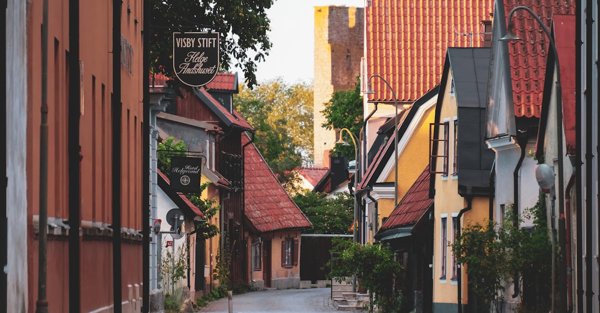 Quaint and colorful houses line a peaceful street in Visby's historic center, Gotland, Sweden.