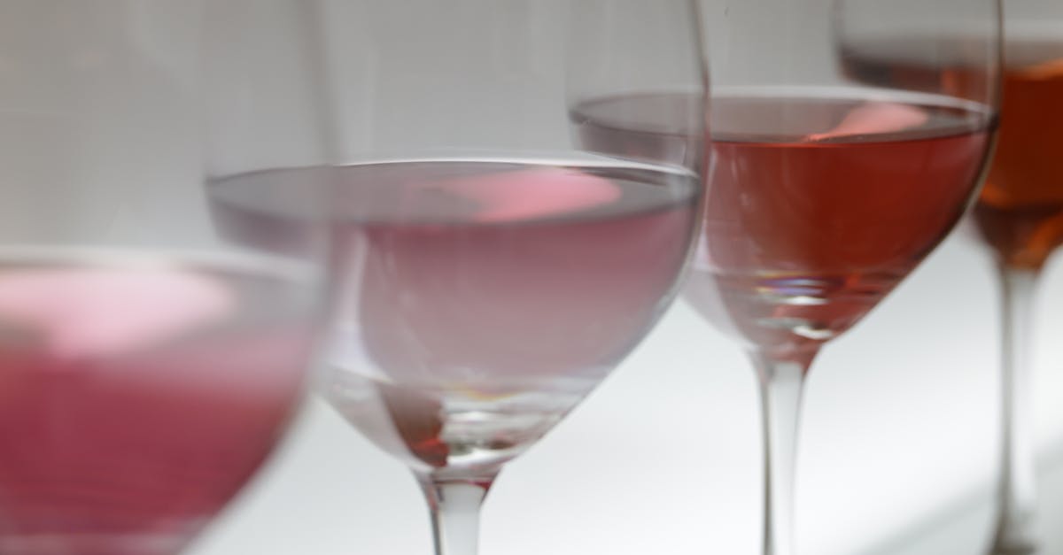 Close-up of various wine glasses filled with rosé in soft lighting, perfect for wine tasting events.