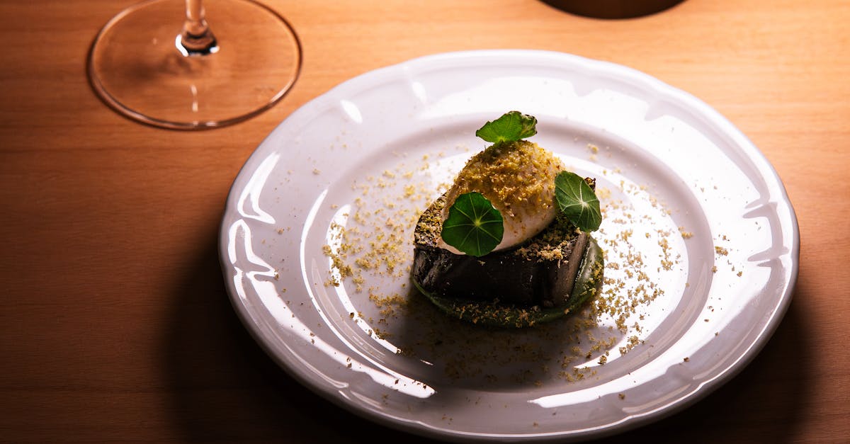 A beautifully plated gourmet dish with a glass of wine in a Tokyo restaurant setting, showcasing fine dining elegance.