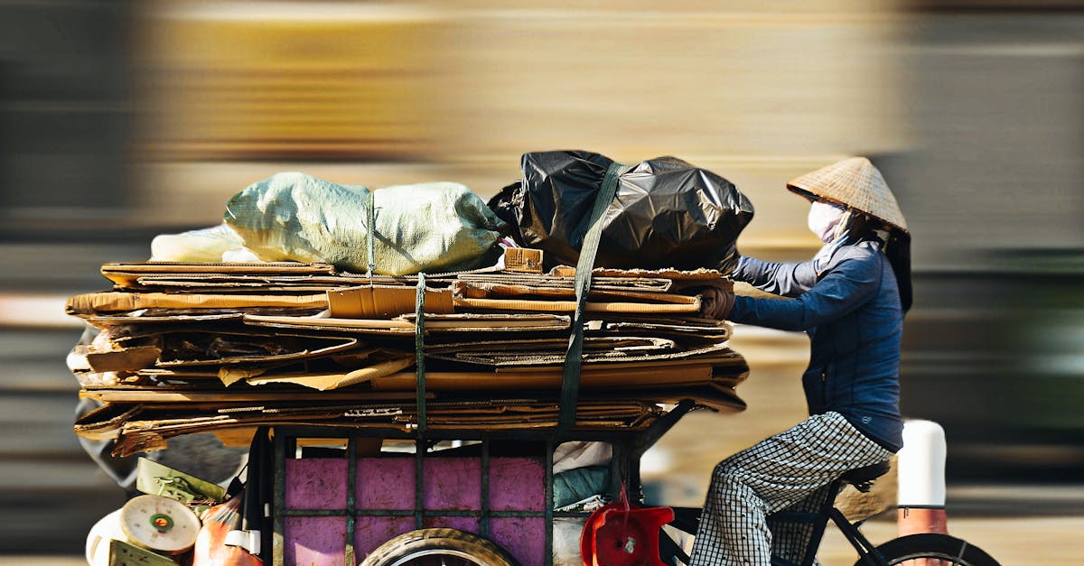 Bicyclist collecting recyclables in Ho Chi Minh City, embodying sustainable living and urban recycling.