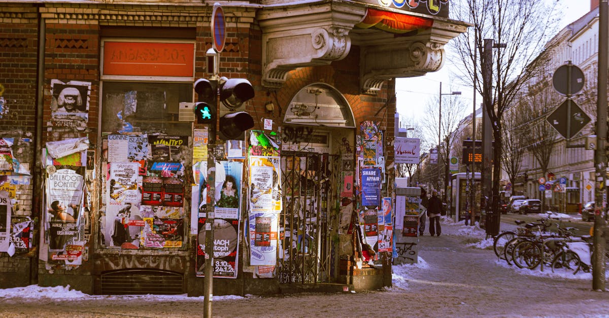 A street corner in Leipzig, Germany adorned with vibrant posters in a wintry setting.