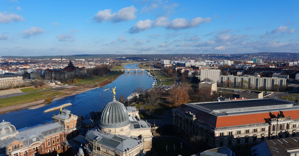 Stunning aerial view of Dresden showing historic architecture and the Elbe River under a clear blue sky.